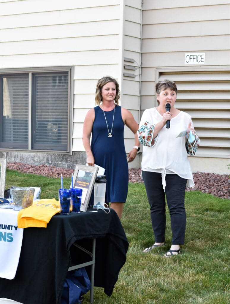 Two women, Keri Cada and Suzanne Horstman, speaking outside at event celebrating receiving new service license