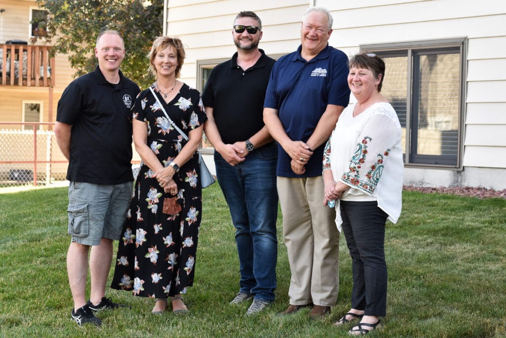 5 smiling people who supported HCO's efforts to get new service license posing for photo